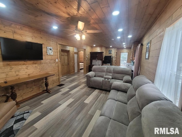 living room featuring wooden walls, ceiling fan, wood ceiling, and wood-type flooring