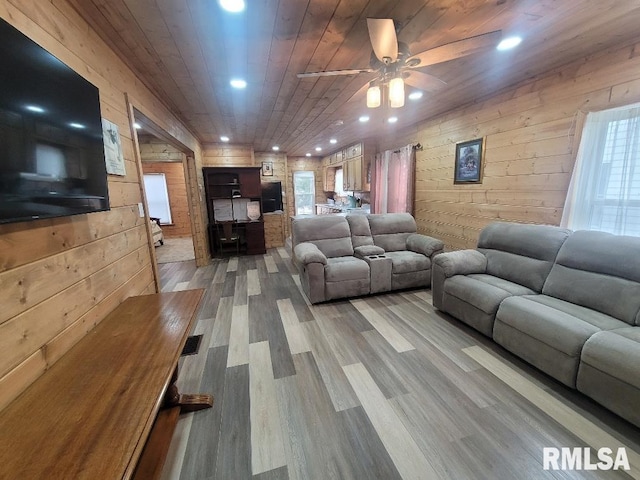 living room featuring hardwood / wood-style floors, ceiling fan, wood walls, and wood ceiling