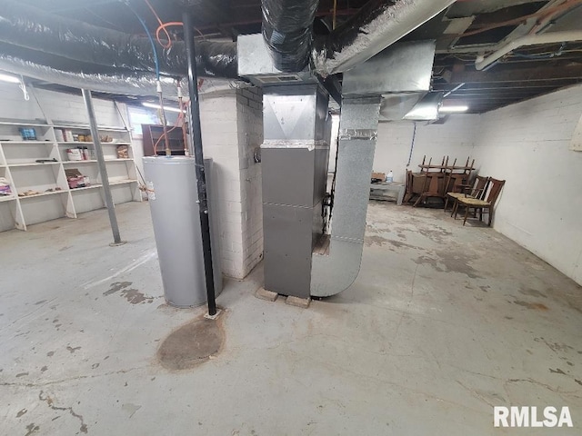 basement featuring heating unit and water heater