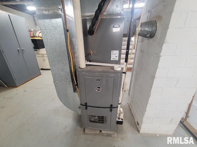 utility room featuring heating unit