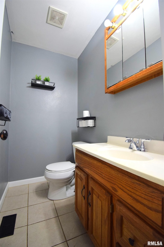 bathroom with tile patterned flooring, vanity, and toilet