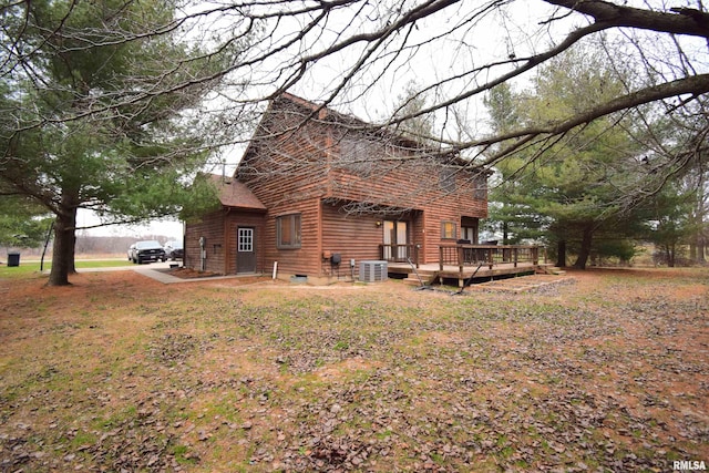 view of side of home featuring central AC unit and a deck