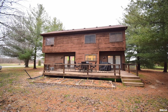 back of property featuring a wooden deck