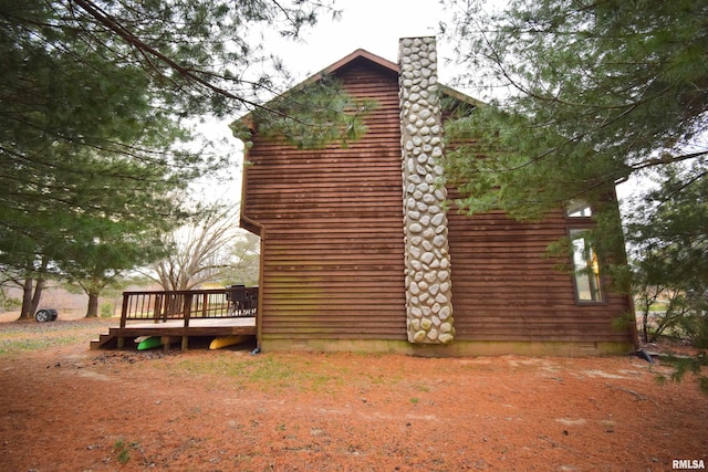 view of side of property featuring a wooden deck