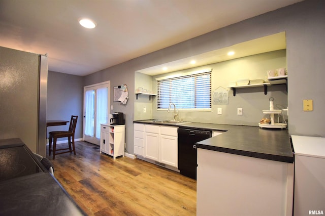 kitchen featuring white cabinets, sink, wood-type flooring, dishwasher, and stainless steel refrigerator