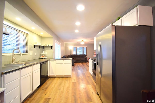 kitchen with dishwasher, sink, stainless steel refrigerator with ice dispenser, kitchen peninsula, and white cabinetry