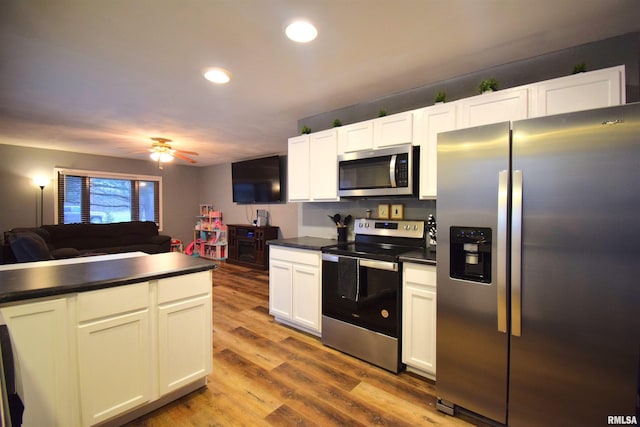 kitchen with white cabinets, appliances with stainless steel finishes, light hardwood / wood-style floors, and ceiling fan