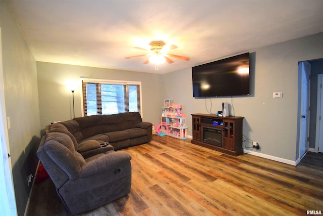 living room featuring ceiling fan and hardwood / wood-style floors