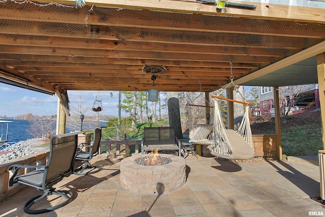 view of patio / terrace featuring a water view and an outdoor fire pit