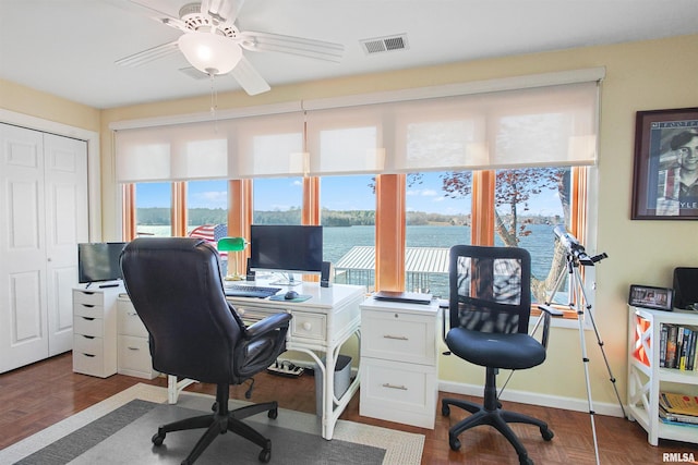 office area featuring ceiling fan and dark parquet flooring