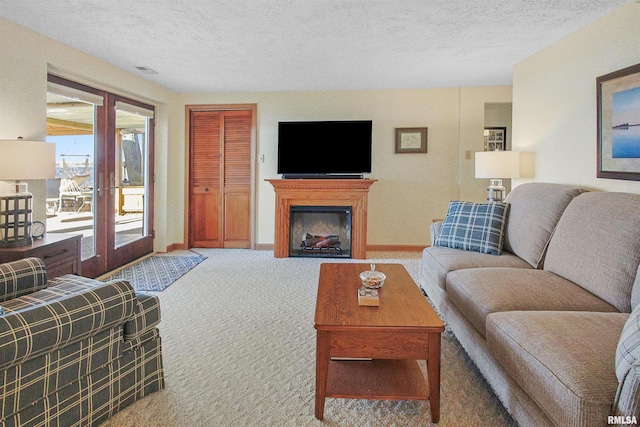 living room with french doors, carpet, and a textured ceiling