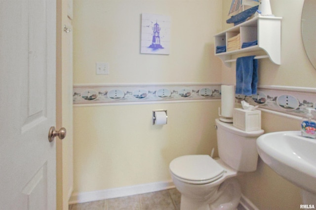 bathroom with tile patterned floors, sink, and toilet