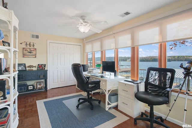 office with ceiling fan and dark parquet flooring