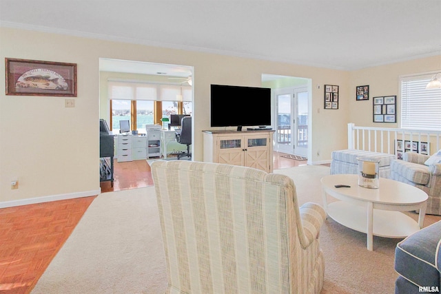 living room with crown molding and light parquet flooring