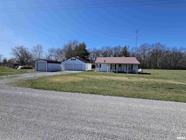 17061 N Fairdrive Ln, Woodlawn, IL 62898 - ranch-style home with covered porch, a garage, an outdoor structure, and a front yard