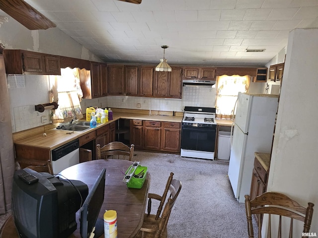 17061 N Fairdrive Ln, Woodlawn, IL 62898 - kitchen featuring sink, pendant lighting, vaulted ceiling, white appliances, and light carpet