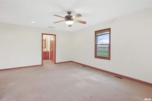 unfurnished room featuring ceiling fan and carpet