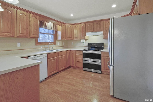 kitchen with stainless steel appliances, light hardwood / wood-style flooring, and sink