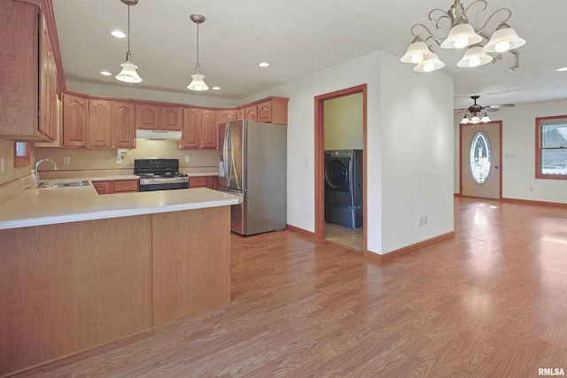 kitchen with ceiling fan with notable chandelier, sink, electric range, washer / dryer, and stainless steel refrigerator