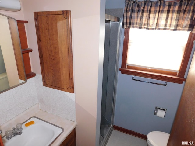 bathroom with vanity, an enclosed shower, and toilet