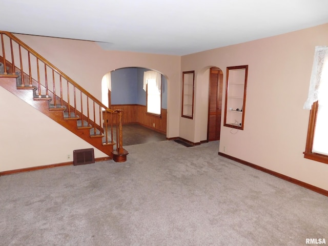 unfurnished living room featuring carpet floors