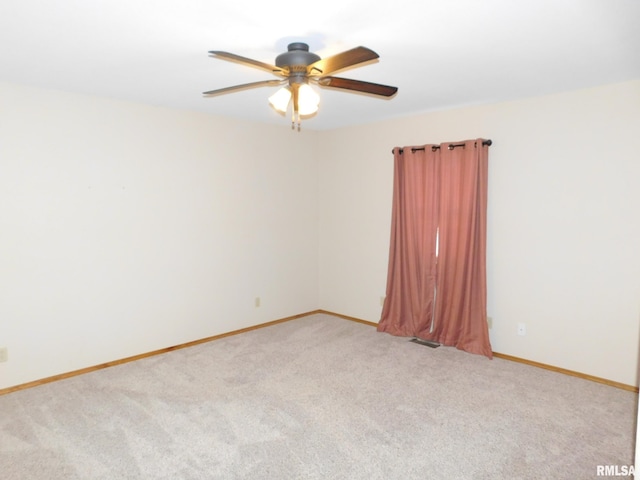 carpeted spare room with ceiling fan