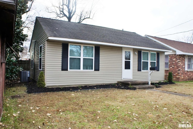 ranch-style house with central AC unit and a front yard