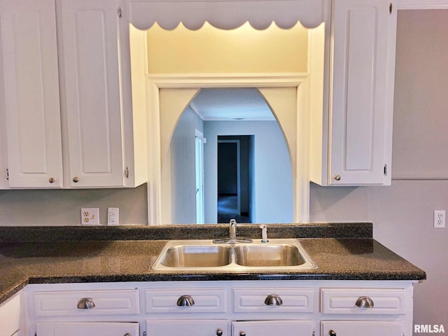 kitchen featuring sink and white cabinets