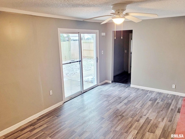 unfurnished room with ceiling fan, wood-type flooring, and a textured ceiling