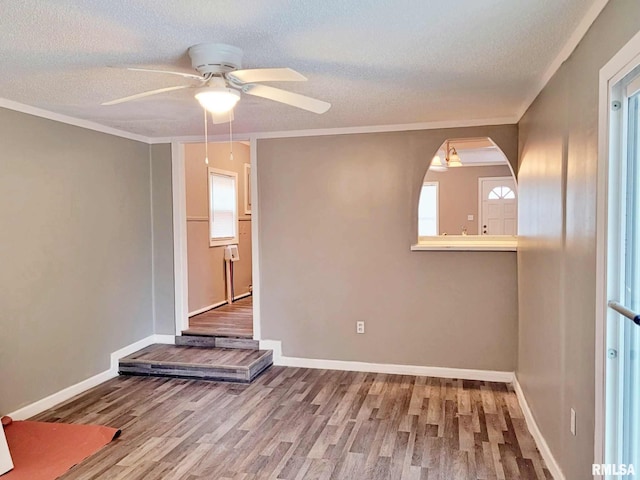 unfurnished room with hardwood / wood-style flooring, ceiling fan, and a textured ceiling