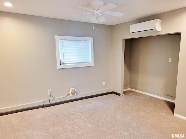 unfurnished bedroom featuring a wall unit AC, ceiling fan, and light carpet