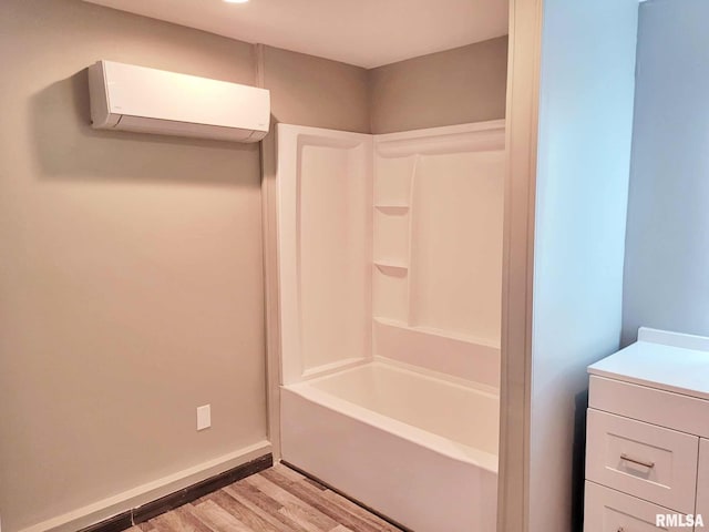 bathroom featuring an AC wall unit, hardwood / wood-style floors, and vanity