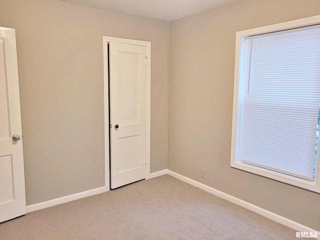 empty room featuring light carpet