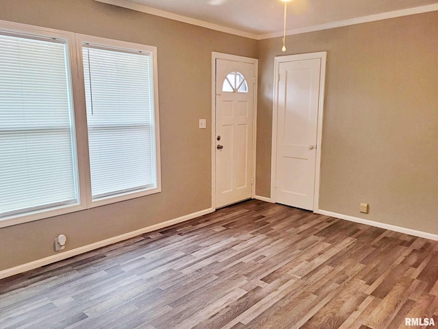 foyer with light hardwood / wood-style flooring and crown molding