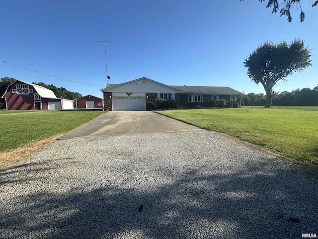 ranch-style home with a front lawn, an outdoor structure, and a garage