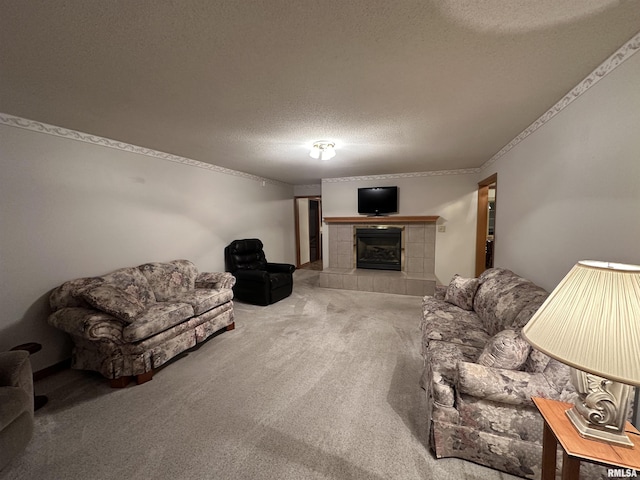 carpeted living room with a tiled fireplace and a textured ceiling