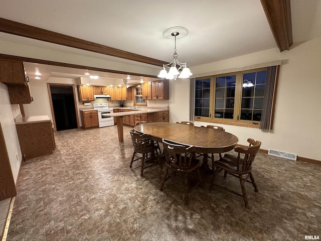 dining room featuring beam ceiling and ceiling fan with notable chandelier