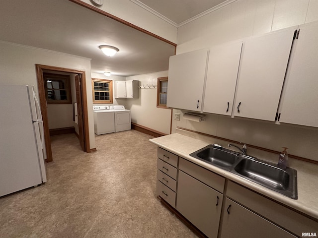 kitchen featuring gray cabinetry, white refrigerator, crown molding, sink, and independent washer and dryer