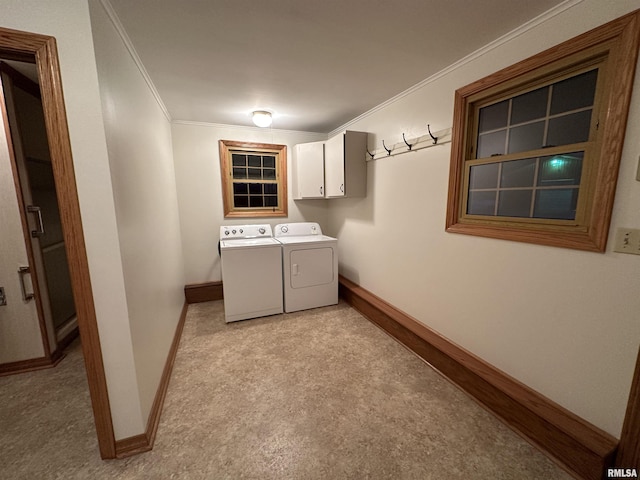 laundry area featuring cabinets, light carpet, washer and clothes dryer, and ornamental molding