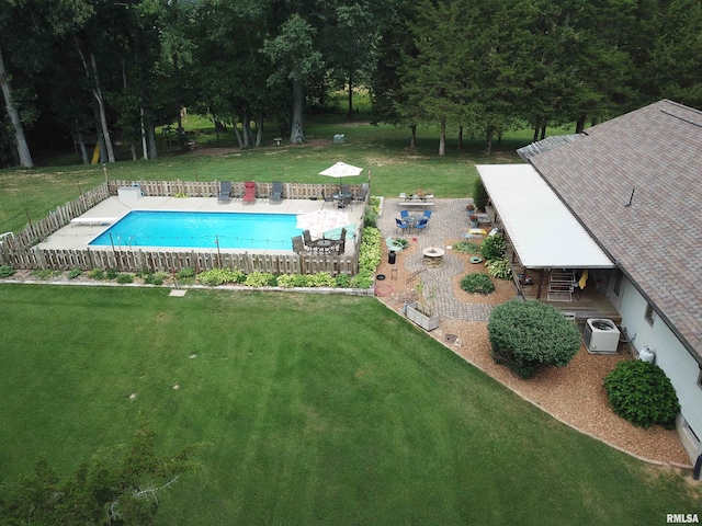 view of swimming pool featuring a patio area and a yard
