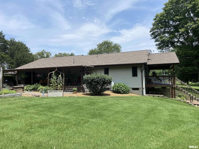 rear view of property with a lawn