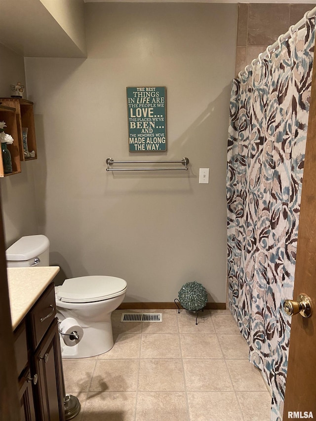 bathroom featuring tile patterned flooring, vanity, and toilet