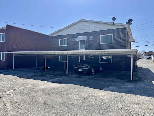 1408 Manning St, Murphysboro, IL 62966 - rear view of house featuring covered parking and brick siding