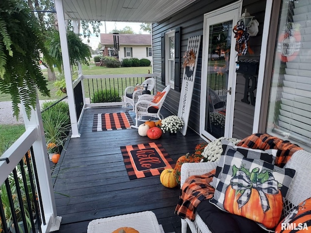 deck featuring a porch and a lawn