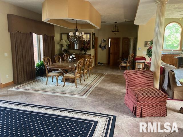 dining area featuring light tile patterned flooring and a chandelier