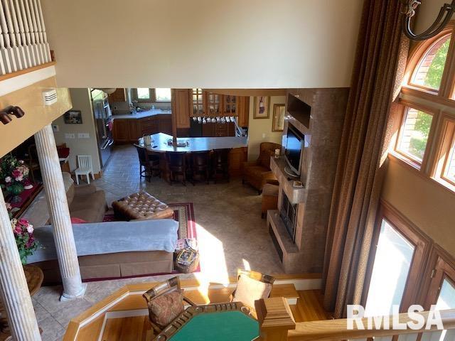 living room with ornate columns and a towering ceiling