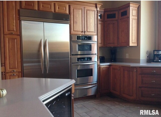 kitchen featuring stainless steel appliances and beverage cooler