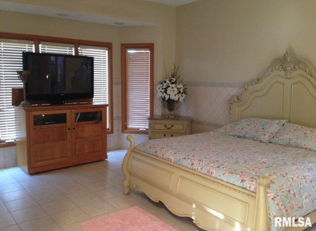 bedroom featuring light tile patterned floors