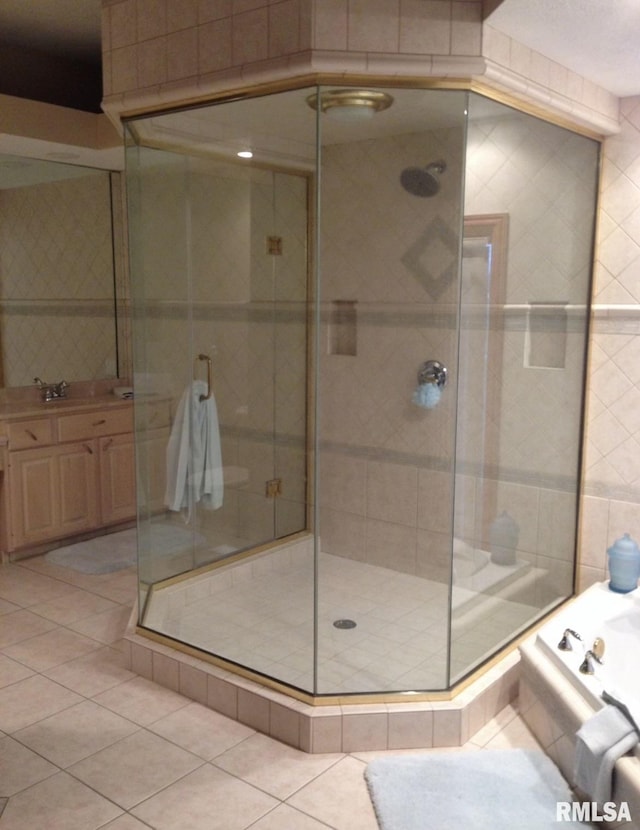 bathroom with tile patterned flooring, vanity, and shower with separate bathtub