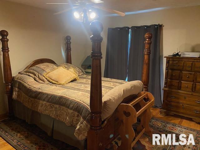 bedroom featuring ceiling fan and hardwood / wood-style flooring